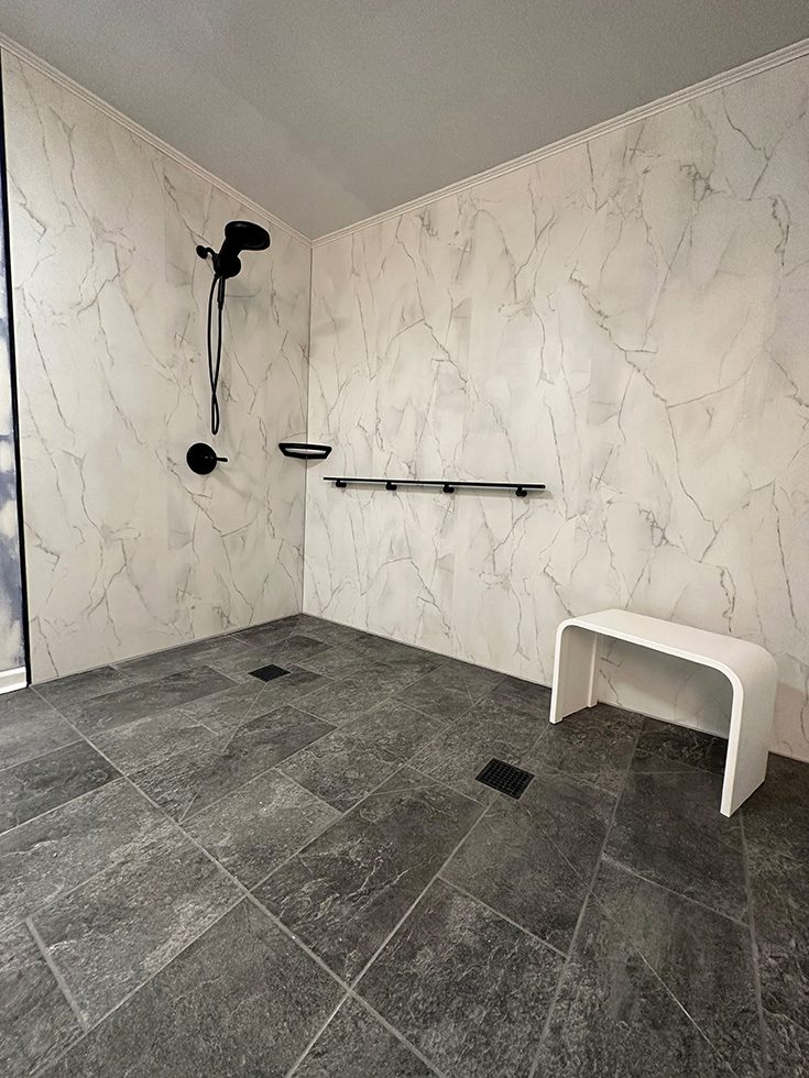 Tip 5 roll in shower white marble wall panels credit JTEK Solutions - Innovate Building Solutions, Bathroom Shower Concepts, Accessible Shower Designs, Modern Bathroom Showers, Roll In Shower Products