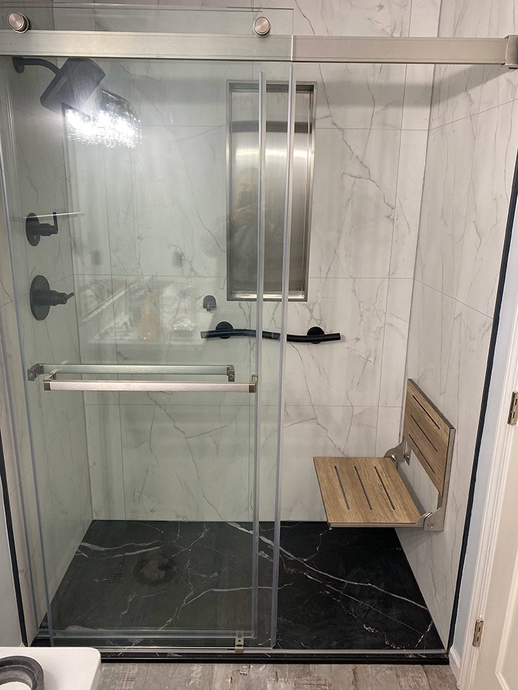 Feature 7 teak fold down age in place shower seat - Innovate Building Solutions, Cleveland Ohio Accessible Showers, Shower Seating Options, Safer Shower Remodels, Custom Walk In Bathroom Shower
