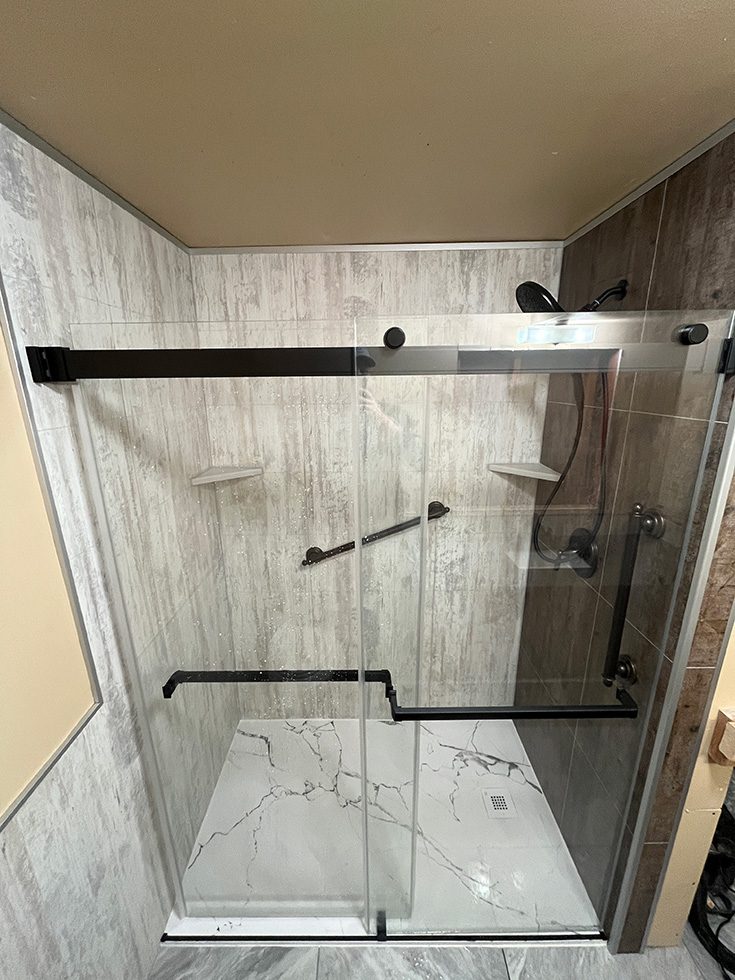 Mistake 2 white marble InnovaStone shower pan with decorative design - Innovate Building Solutions, Custom Shower Bases, Glass Shower Doors, Walk In Shower Renovations, Bathroom Shower Remodeling